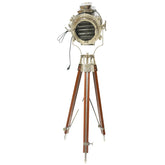 An adjustable tripod spotlight lamp with a silver aluminum body and a wooden tripod stand, showing a spotlight lens at the top and a base that touches the ground.